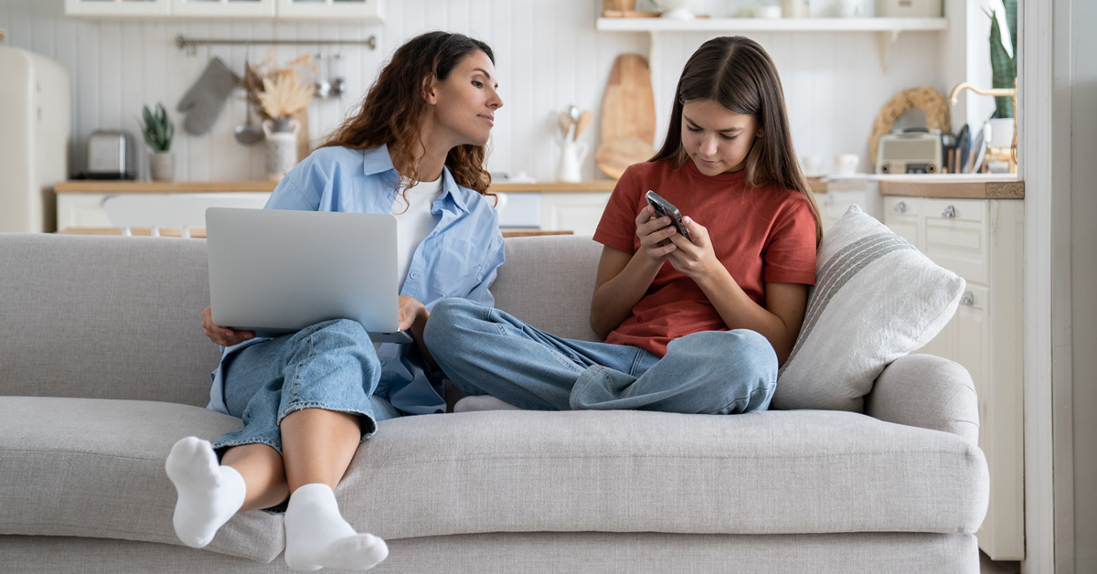 Mom looking towards daughter's phone